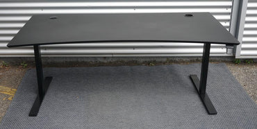 Frontbillede af Dencon hæve-sænkebord 160x90 i sort linoleum med affasede kanter og kabelbakker.