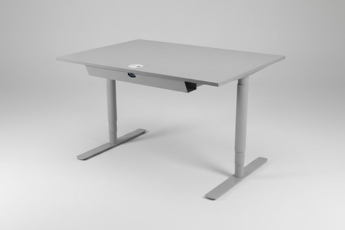 Denconi hæve-sænkebord 120x80 cm i lysegrå laminat med robust T-stel, set fra skrå vinkel.