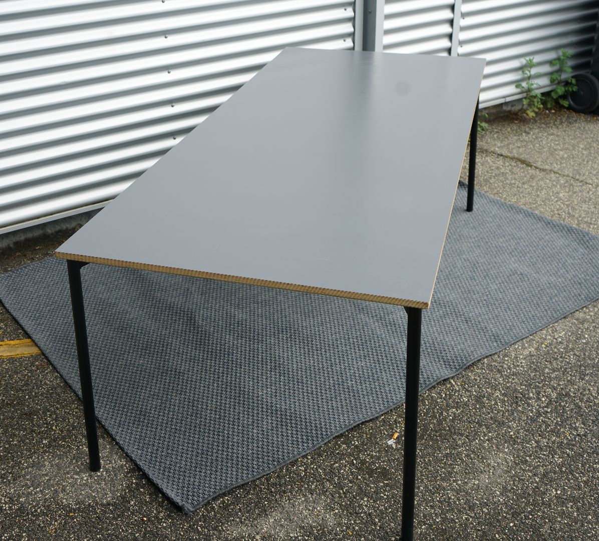 Sideprofil af Fumac bord 210x90 i antracitgrå med robust bordplade og krydsfinerkanter.