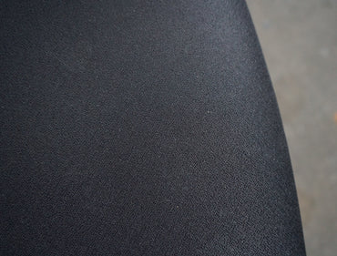 Close-up af slidstærk sort Extreme-polstring og detaljer på kontorstolens armlæn og sæde.