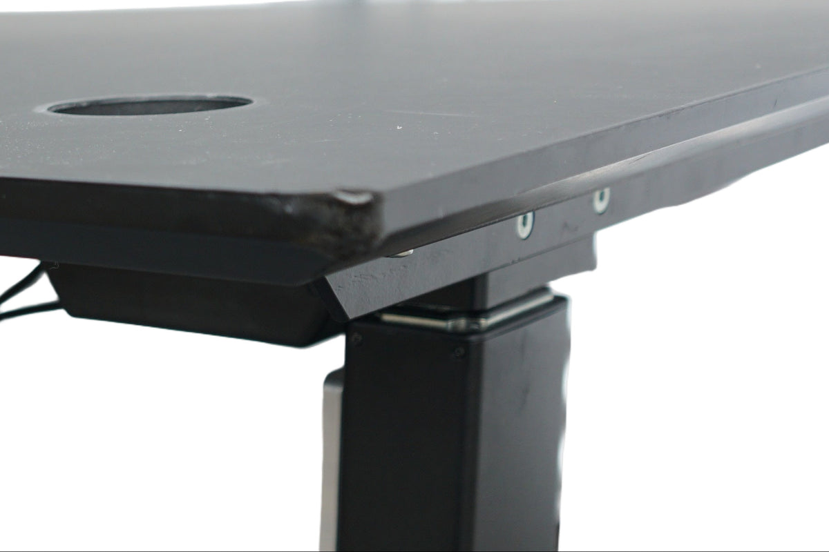 Pop-up stikkontakt integreret i Rumas hæve-sænkebord i sort linoleum