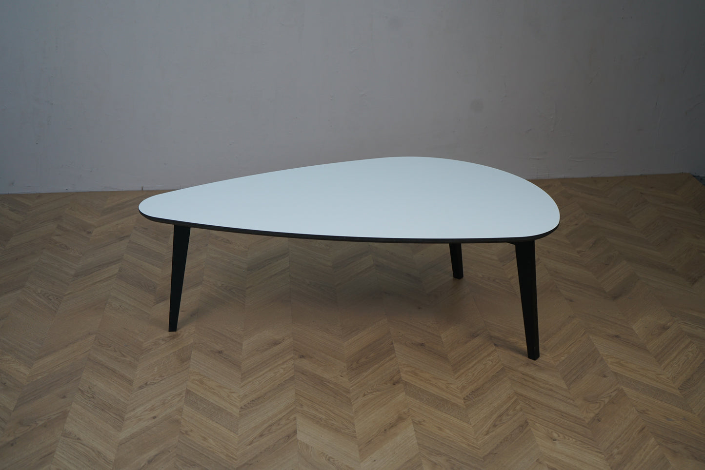 Sofabord med hvid bordplade og sorte ben set forfra – 130 cm langt