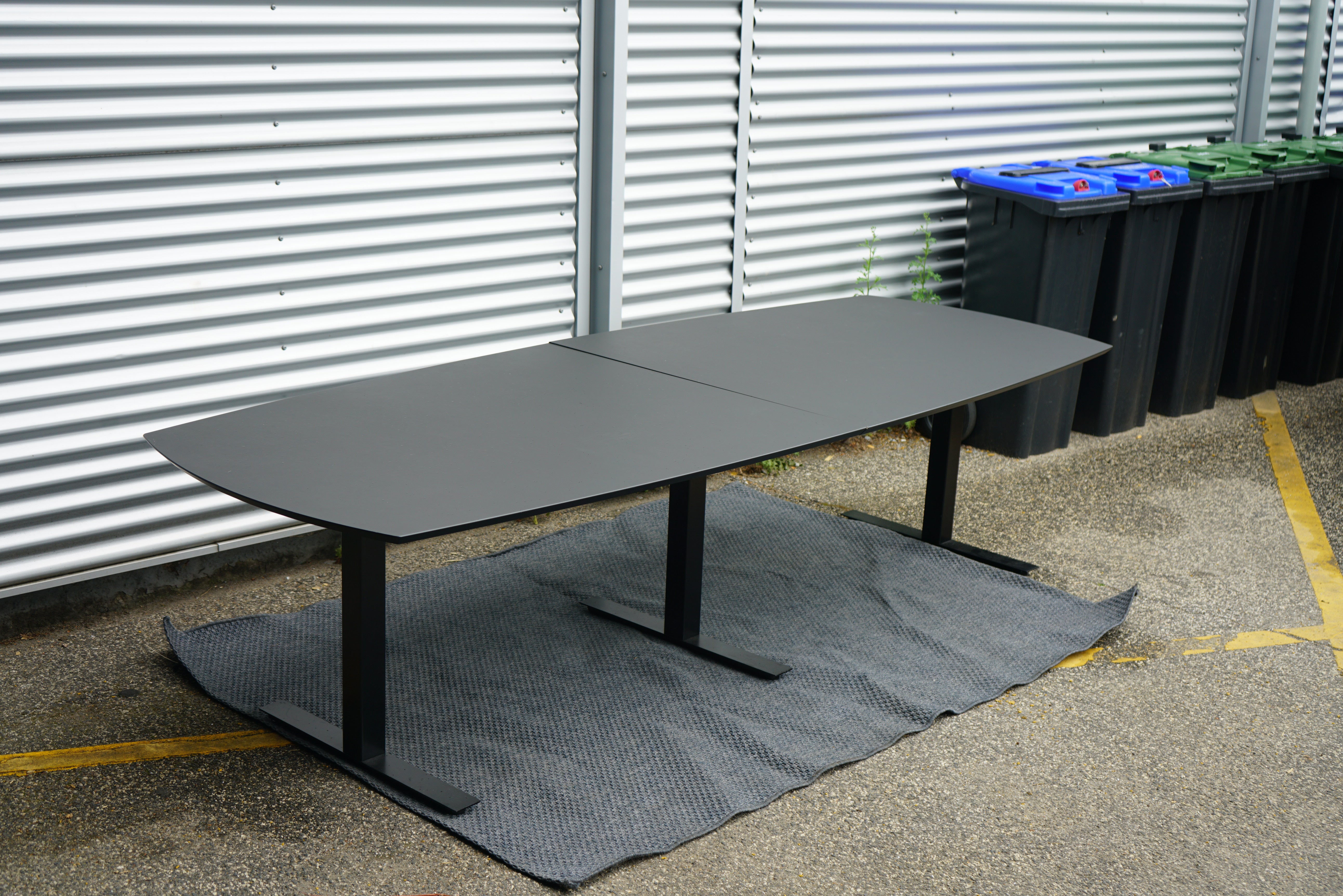 Dencon Delta konferencebord i sort linoleum set i skrå vinkel, 270x120 cm, med affasede kanter.