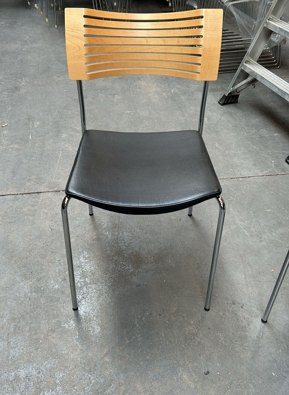 Fritz Hansen Runner stol set fra siden med sort lædersæde og krom stel