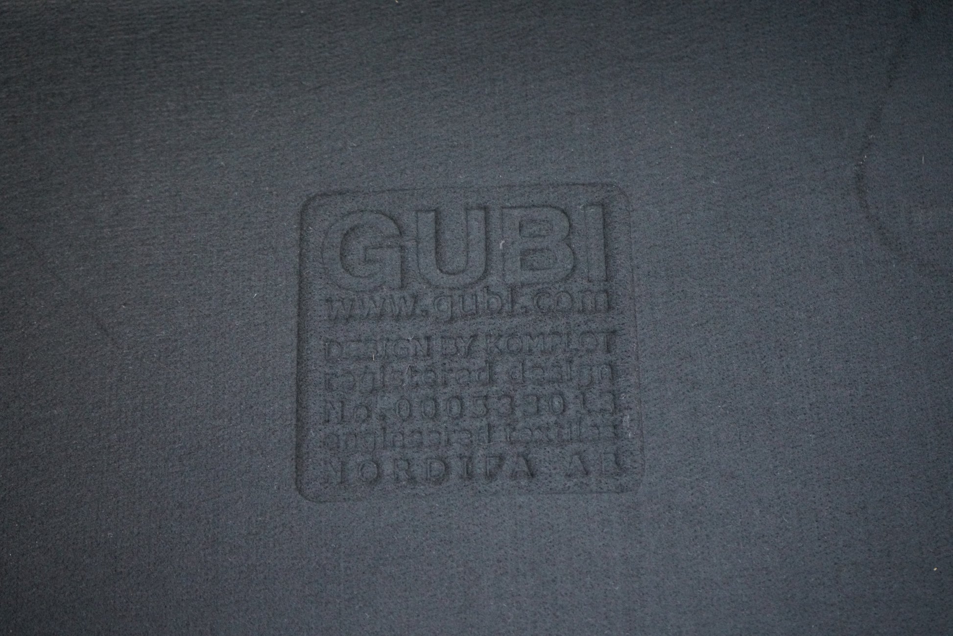 GUBI logo på loungestol i antracit filt