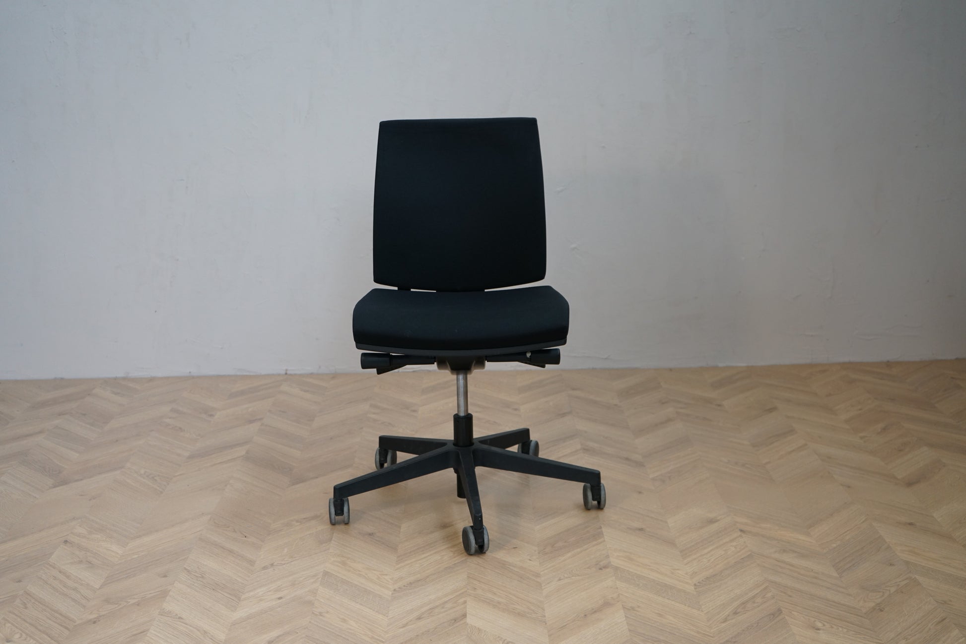 Interstuhl kontorstol i sort med ergonomisk design og justerbar ryg set forfra