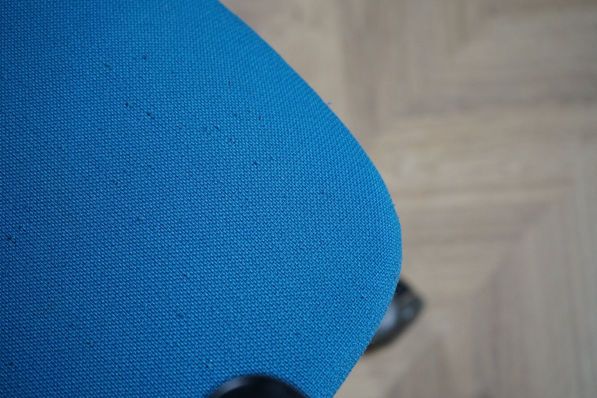 Nærbillede af Kinnarps Plus turkis kontorstols polstrede sæde i slidstærkt stof