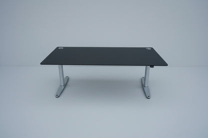 LINAK hæve-sænkebord 180x90 cm med sort linoleum og gråt stel set forfra