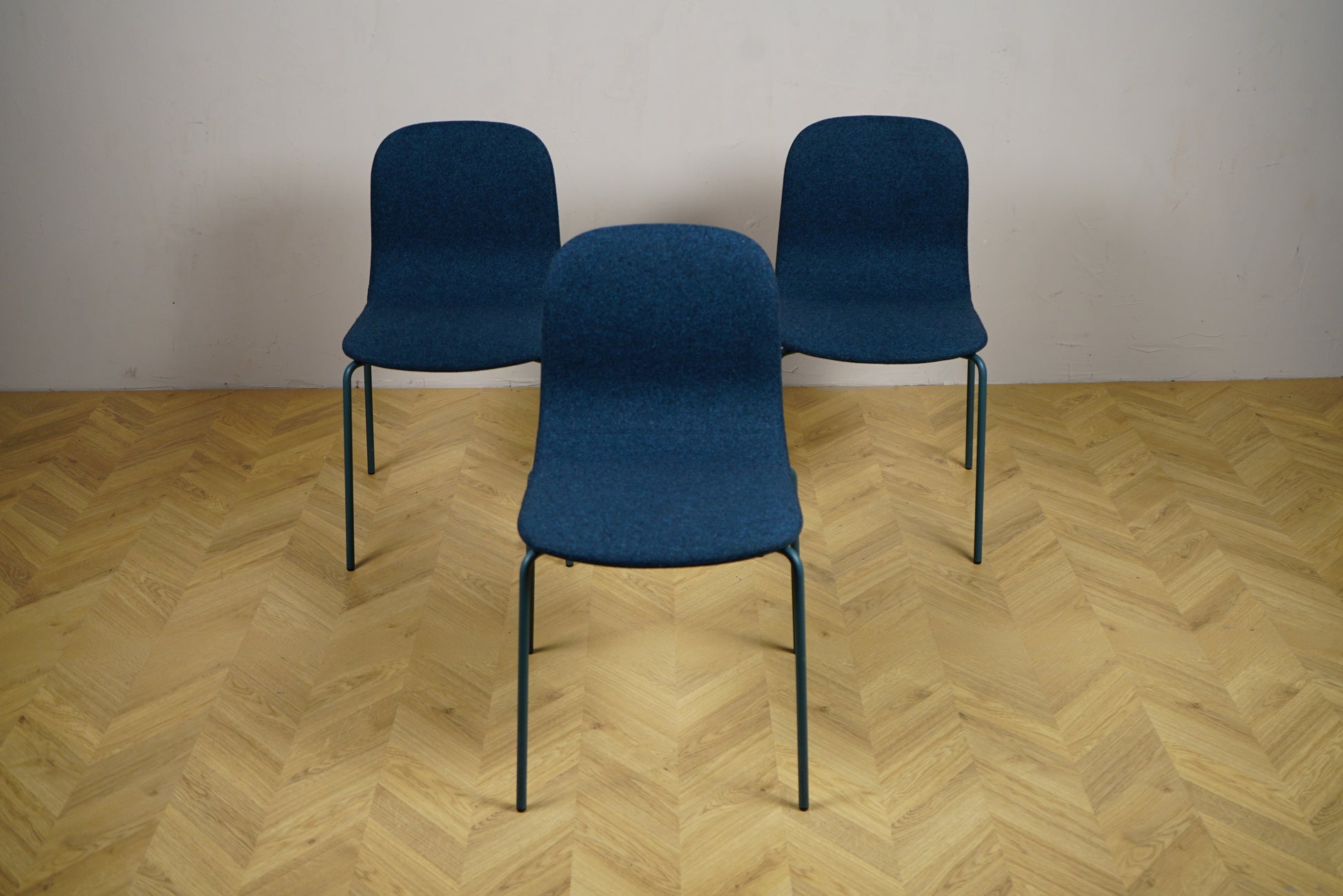 Frontbillede af 3 Materia stabelbare stole i mørkeblå uldstof med siddehøjde 46 cm – ideel som spisestol, mødestol eller loungestol.