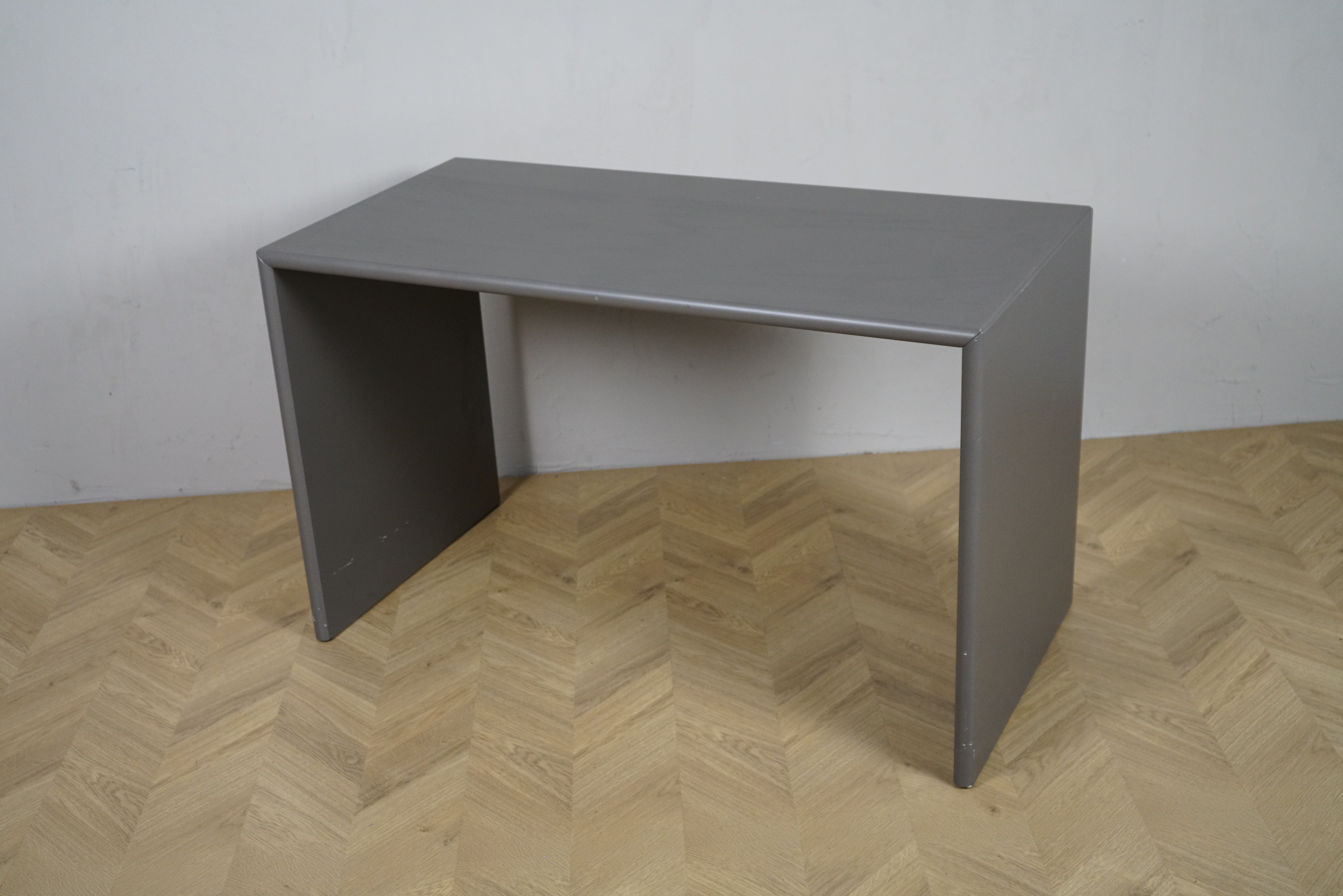 Montana Monterey skrivebord i grå finish set fra en skrå vinkel, 120×60×74 cm, minimalistisk og moderne dansk design.
