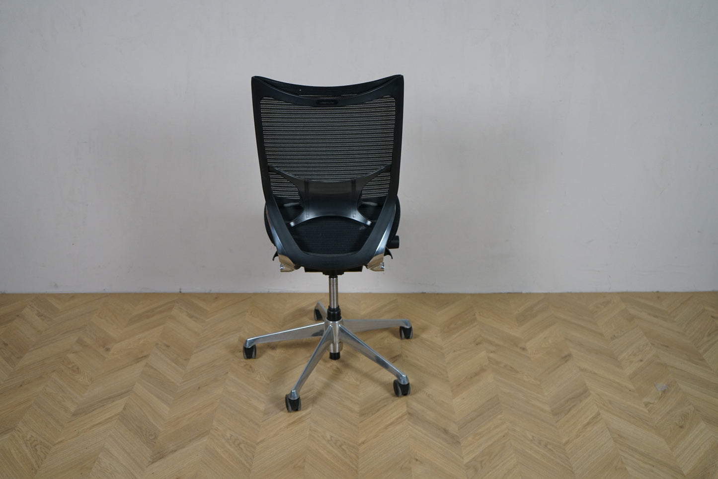Okamura Baron kontorstol uden armlæn set bagfra, med sort mesh-ryg og krom fodkryds.