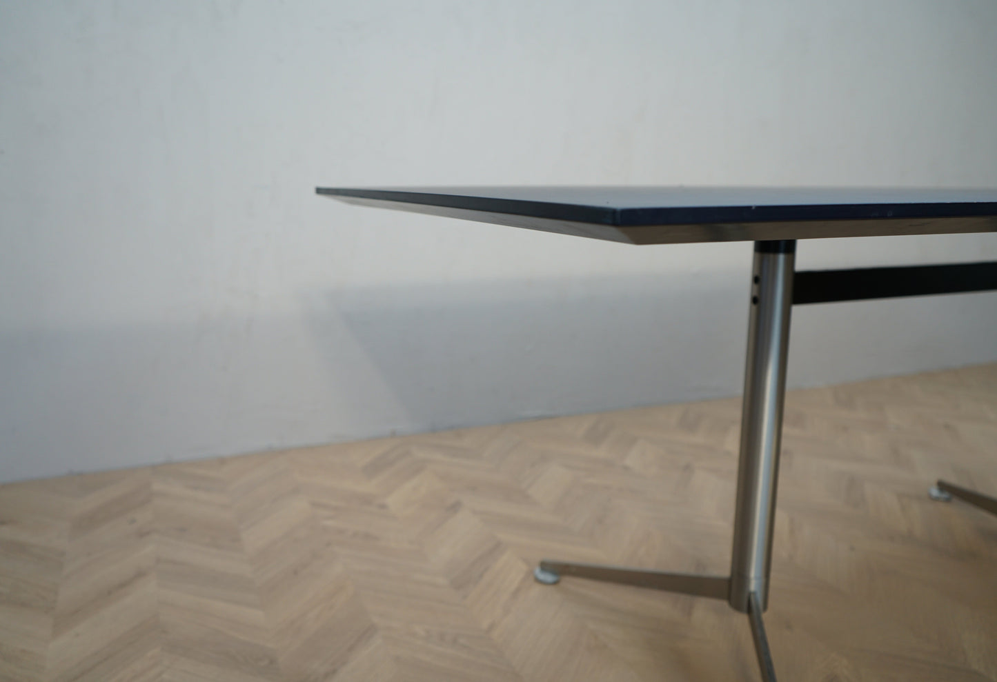 Frontdetalje af Paustian Spinal mødebord med sort linoleum og affaset kant.