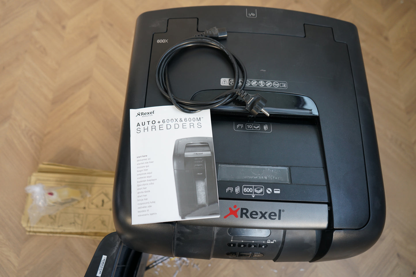Ovenfra af Rexel AUTO+ 600X & 600M makulator med automatisk dokumentføder, strømkabel og manual.