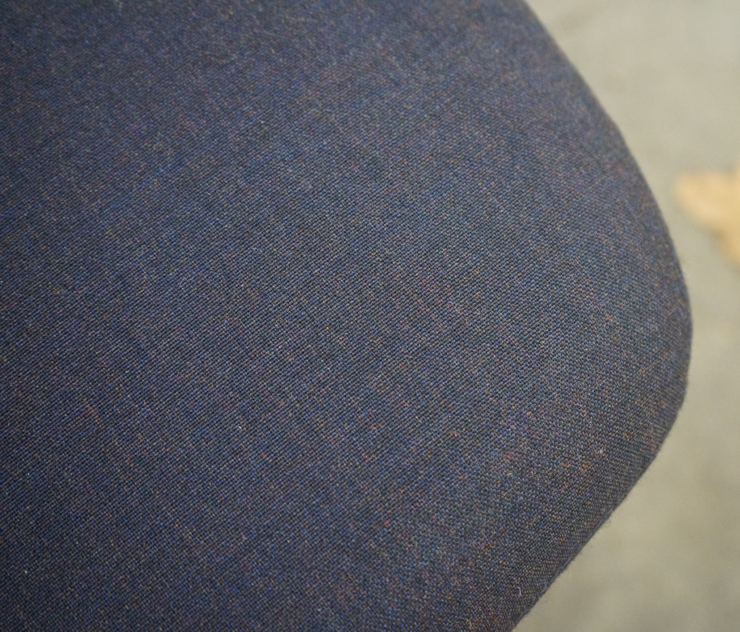 Close-up af Savo kontorstolens mørkeblå polstring og krom stel med armlæn