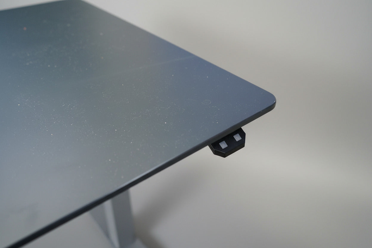 Close-up af antracitgrå nano laminat bordplade med ergonomisk mavebue på Scanoffice hæve-sænkebord