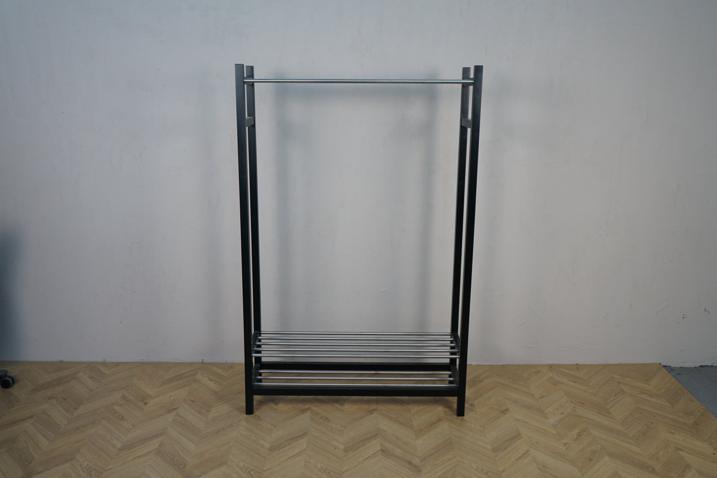 Sort tøjstativ i metal med bøjlestang set forfra